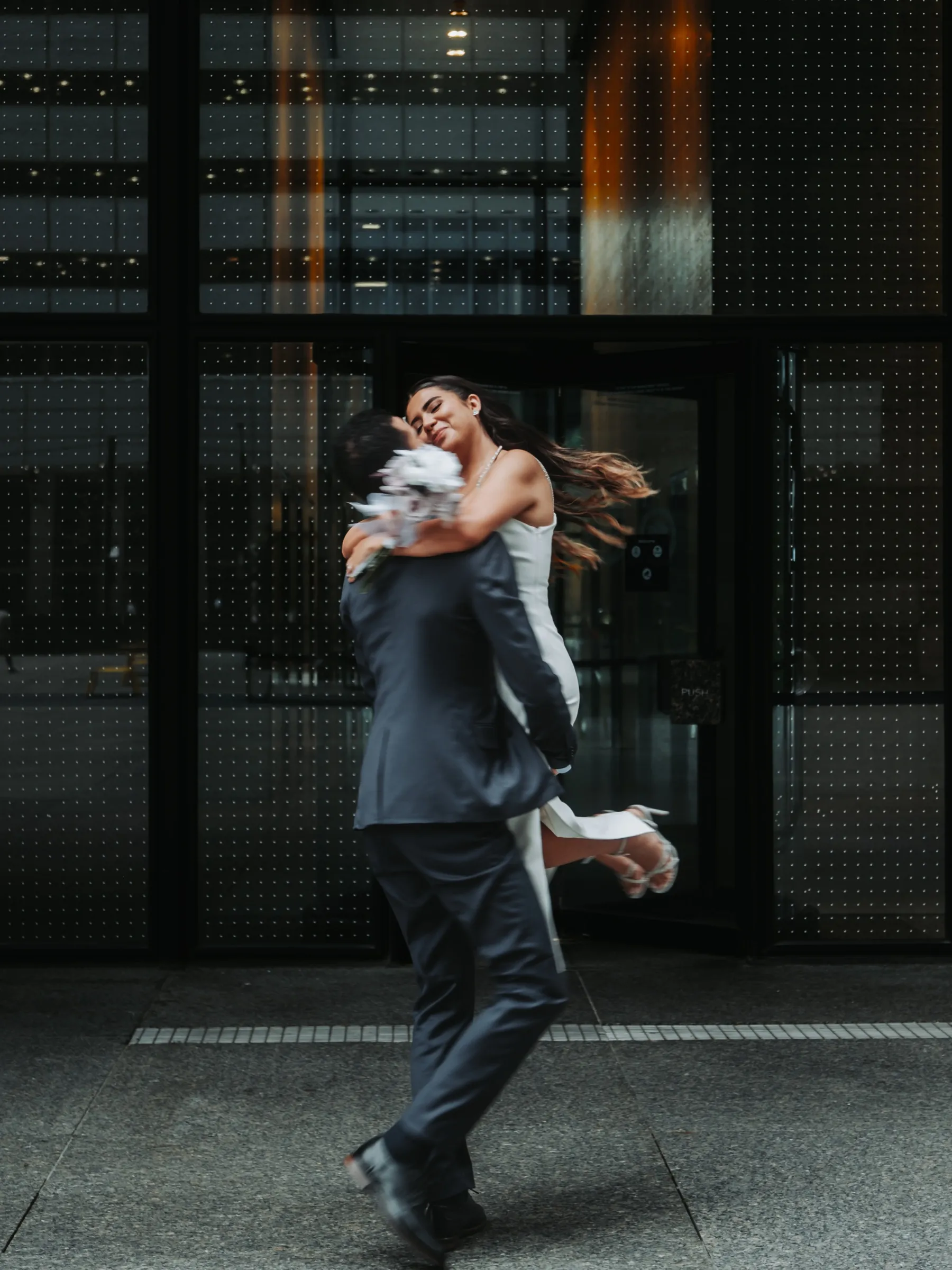 Signature soft motion blur frame, Aziz spinning Alex off her feet, hair and heels flying, by AD Photography