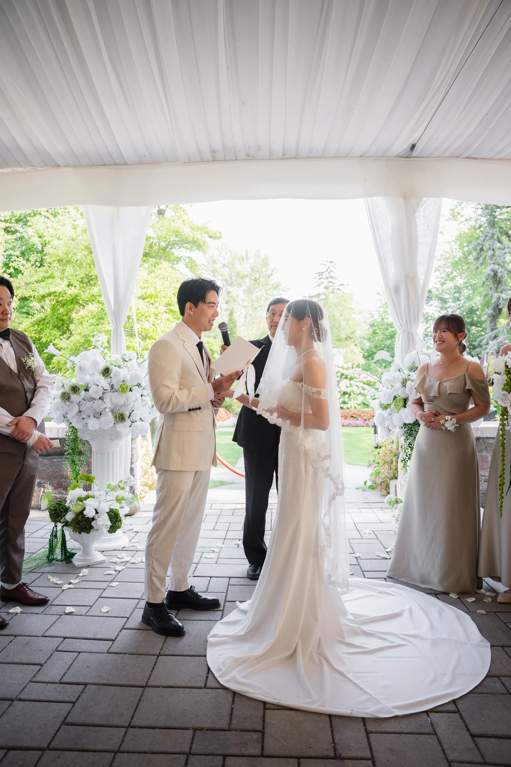 Nelson reading his vows to Josie under the white draped ceremony tent at Guild Park, by AD Photography