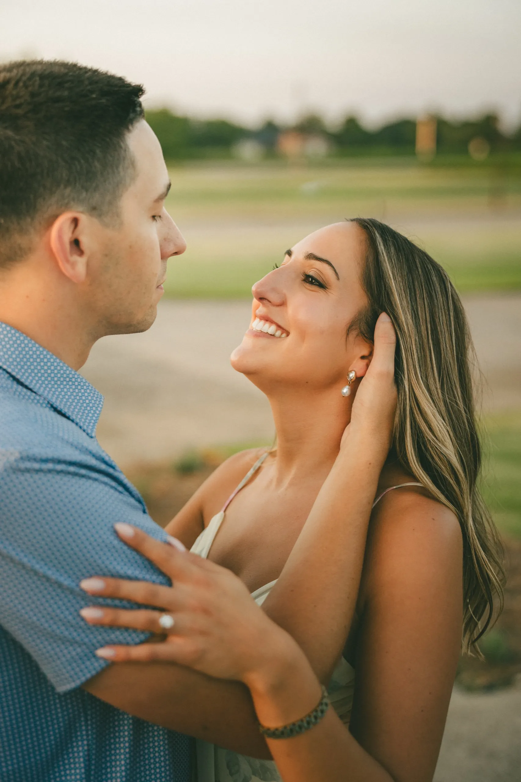 Donald's hand in Ashley's hair as she looks up at him in the last of the light, by AD Photography