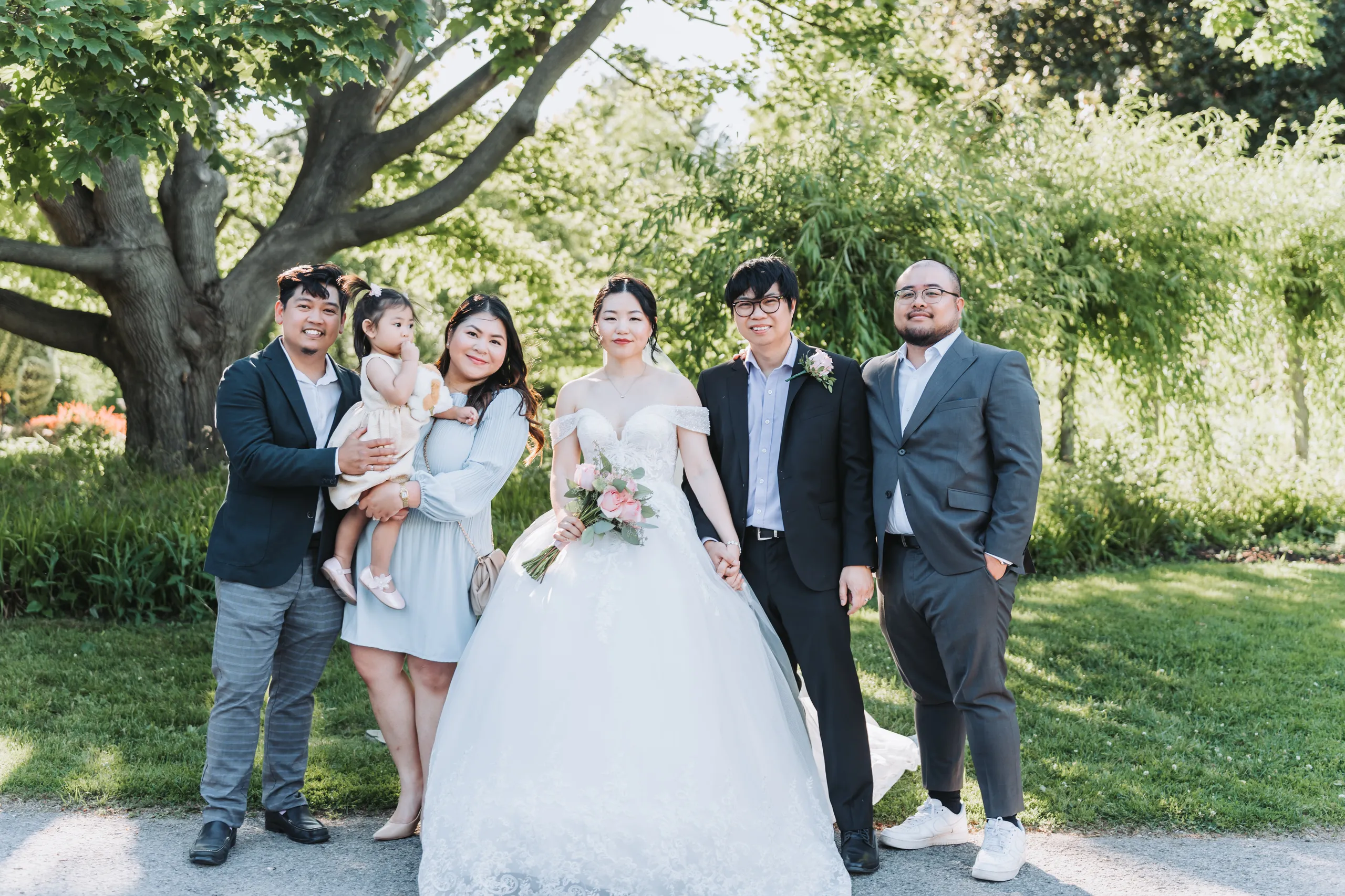 Family portrait with a toddler under the willow at Karen and Micheal's Botanical Gardens wedding, by AD Photography