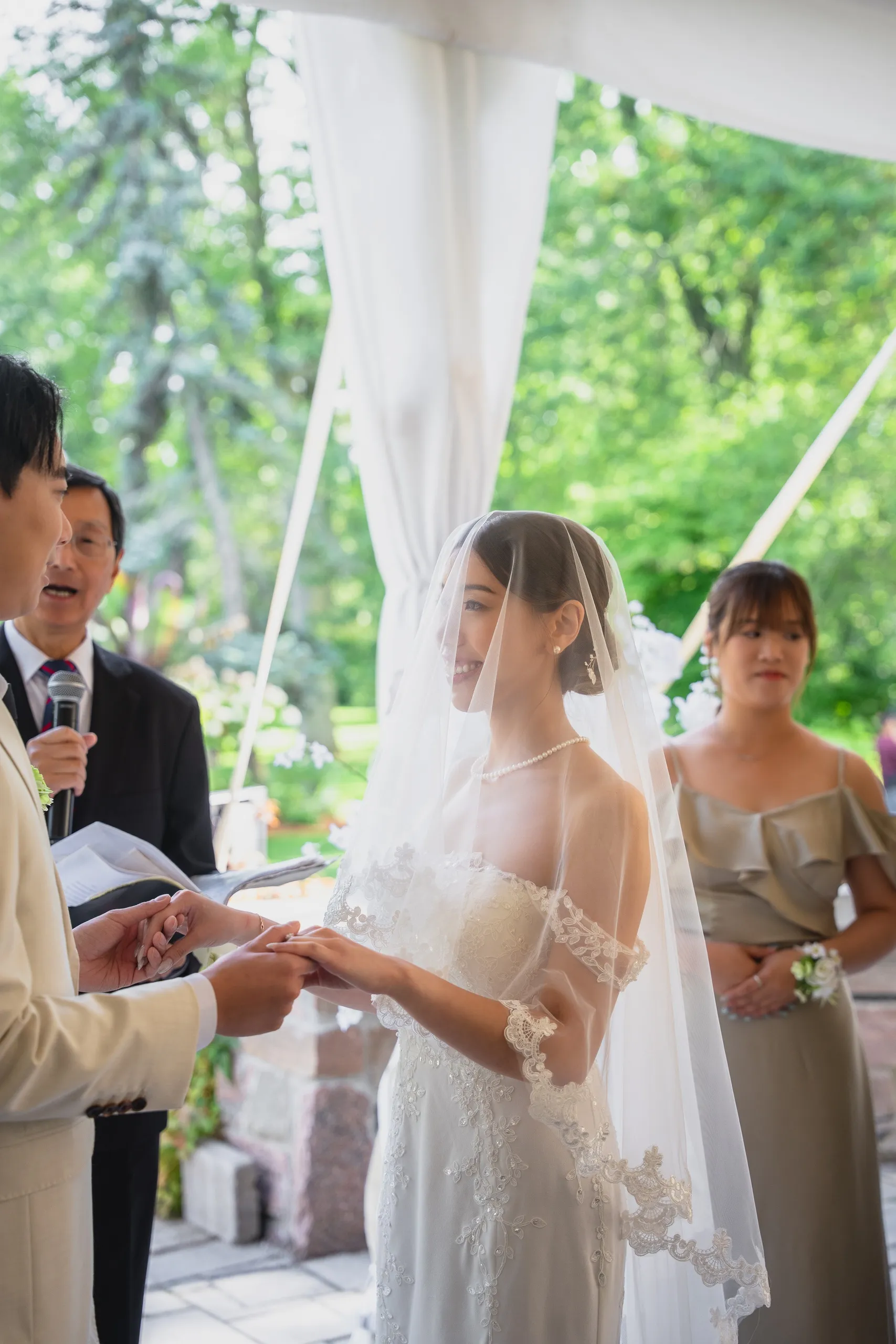 The officiant reading aloud as Nelson takes Josie's hand at their Scarborough wedding, by AD Photography