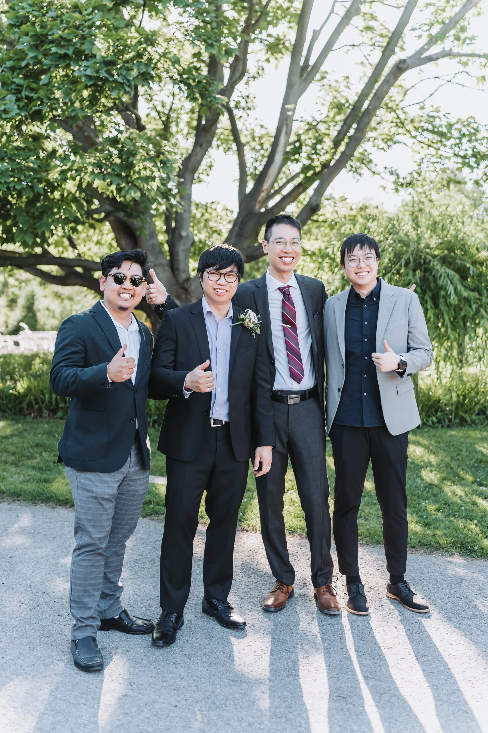 Four of Micheal's friends giving the camera a thumbs up on the garden path in Niagara Falls, by AD Photography