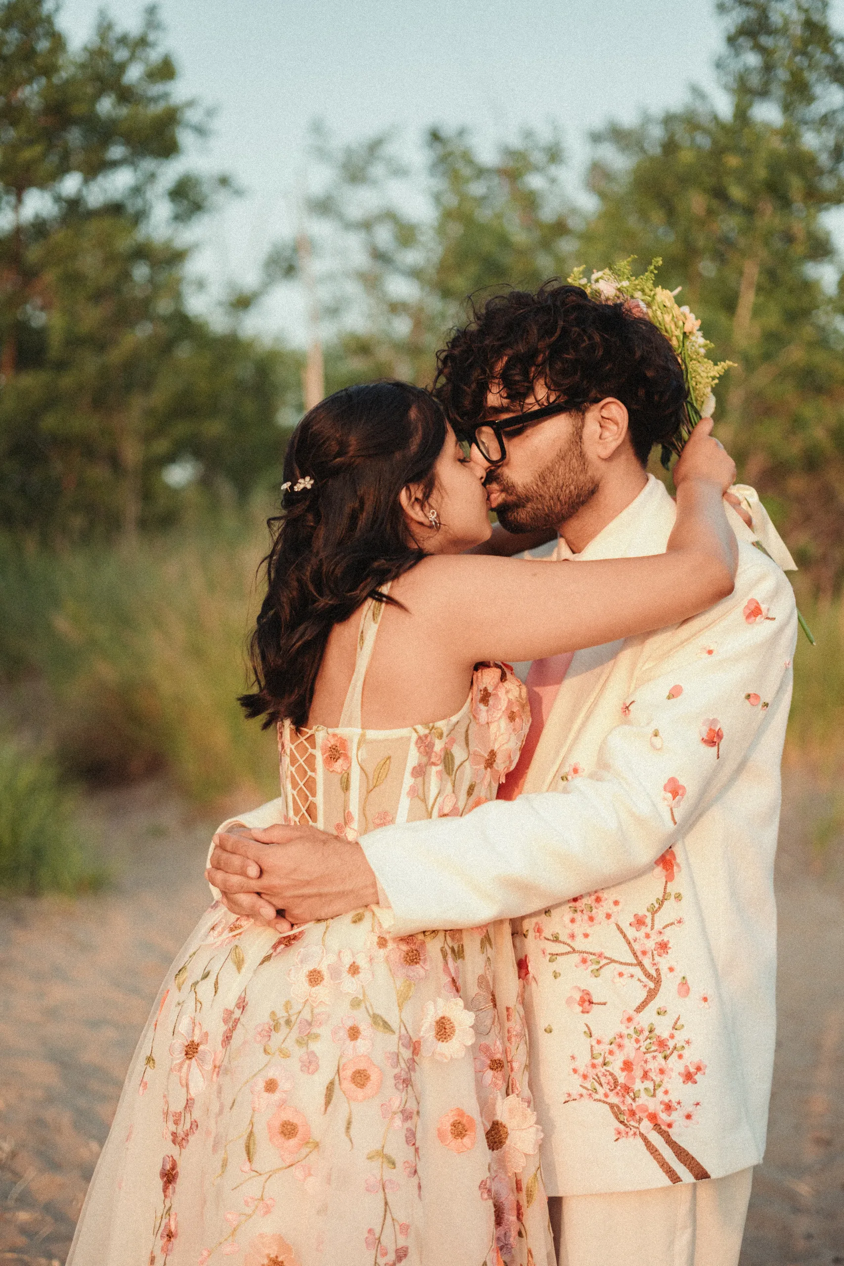 Harsh kissing Payal from behind, the embroidery of her gown in detail, Toronto Islands beach, by AD Photography