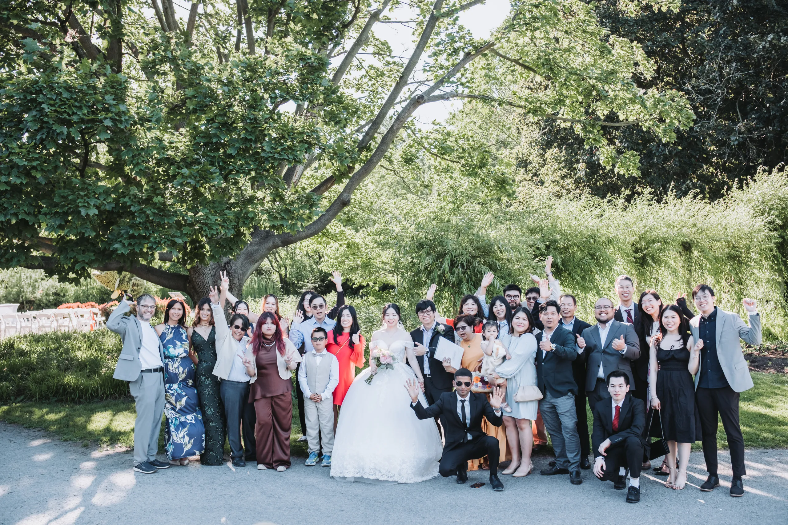 The whole group cheering together with Karen and Micheal at the Niagara Parks Botanical Gardens, by AD Photography