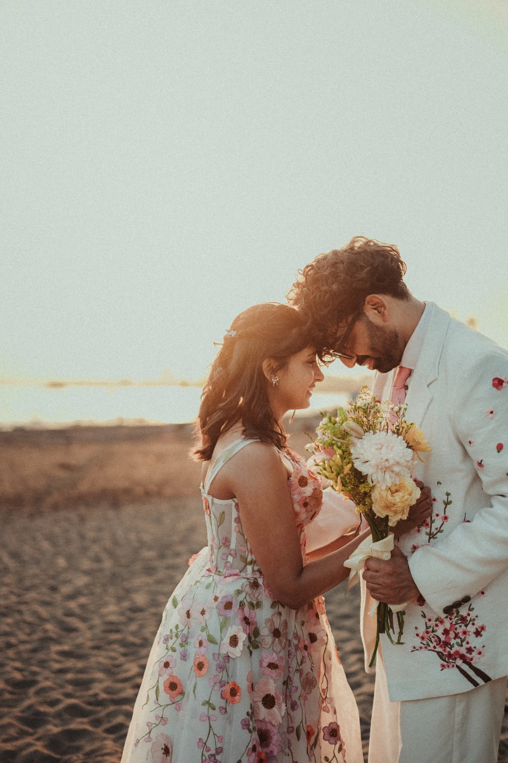 A hazy profile frame of Harsh and Payal's foreheads touching by the water, Toronto Islands, by AD Photography