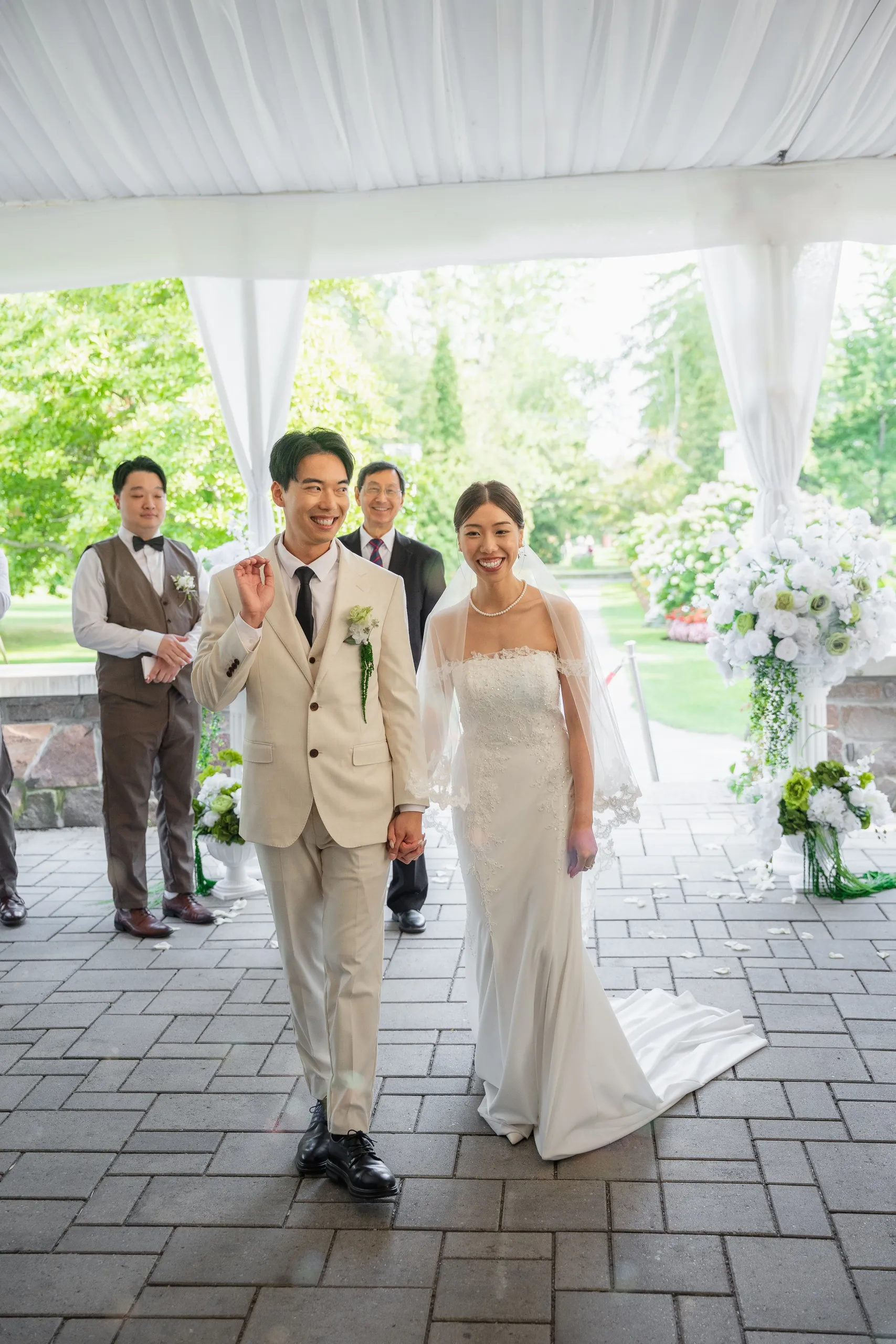 Josie and Nelson walking back up the aisle hand in hand, guests clapping behind, by AD Photography
