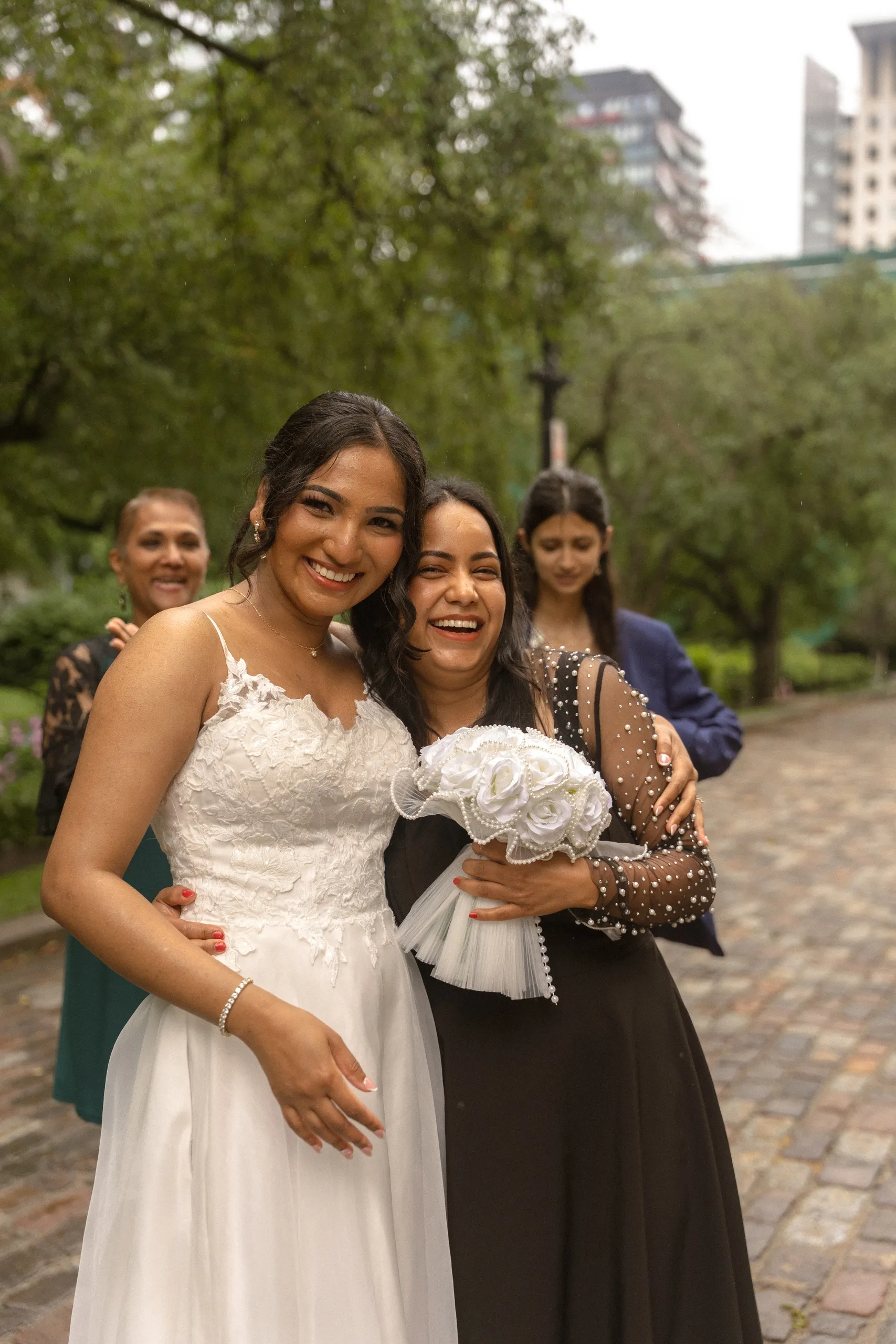 Bride laughs with the friend who caught her bouquet, by AD Photography