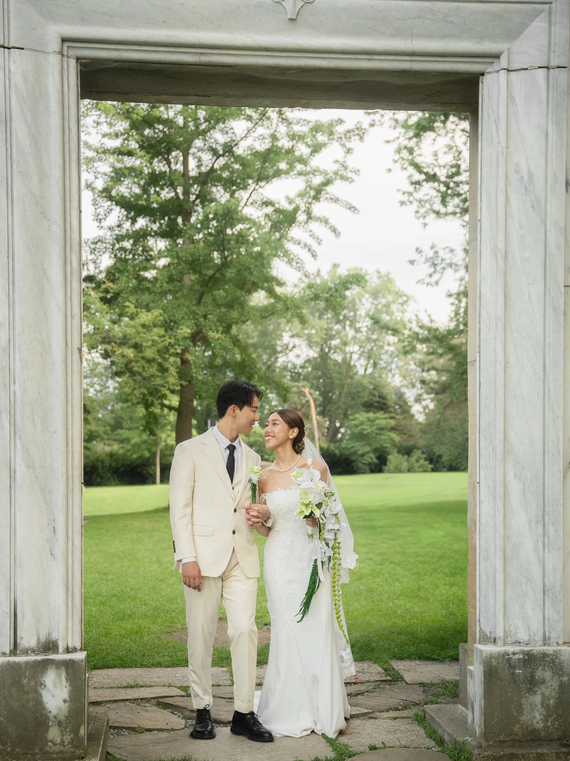 Josie and Nelson framed in the marble doorway at Guild Park with the lawn beyond, by AD Photography