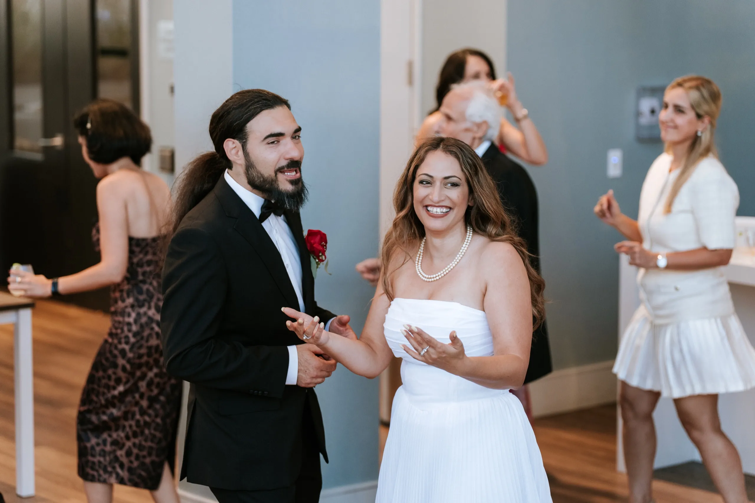 Zoha and Moe clapping in the middle of the floor as the anniversary dancing starts, by AD Photography