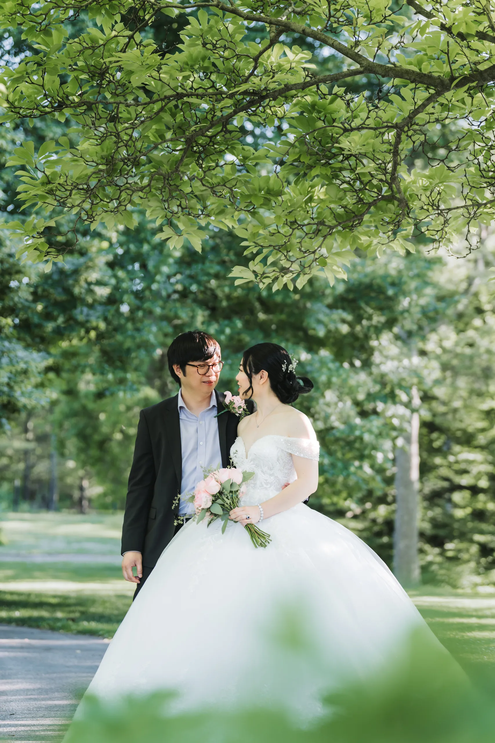 Karen and Micheal in a quiet moment shot through layered garden leaves in Niagara Falls, by AD Photography