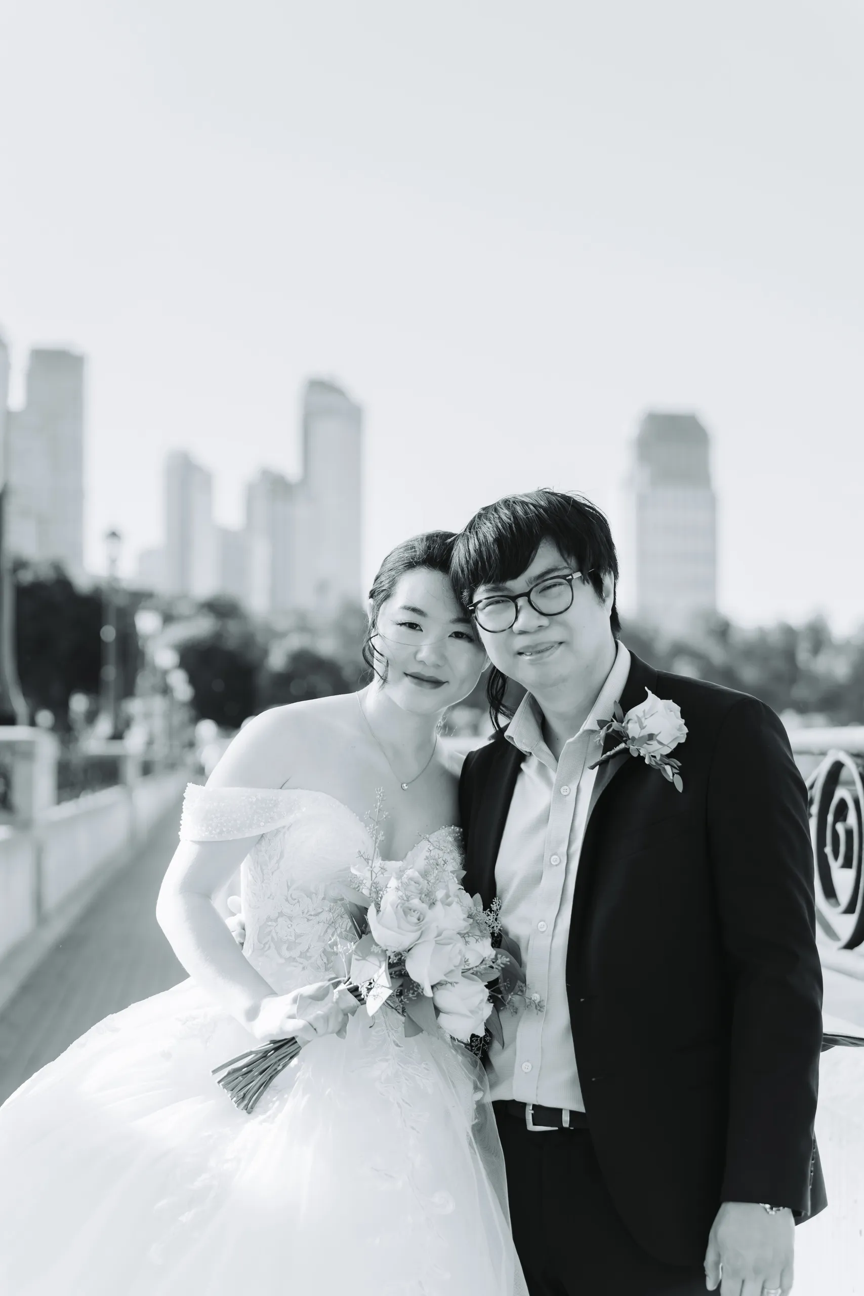 Black and white portrait of Karen and Micheal with the Niagara Falls skyline soft behind them, by AD Photography