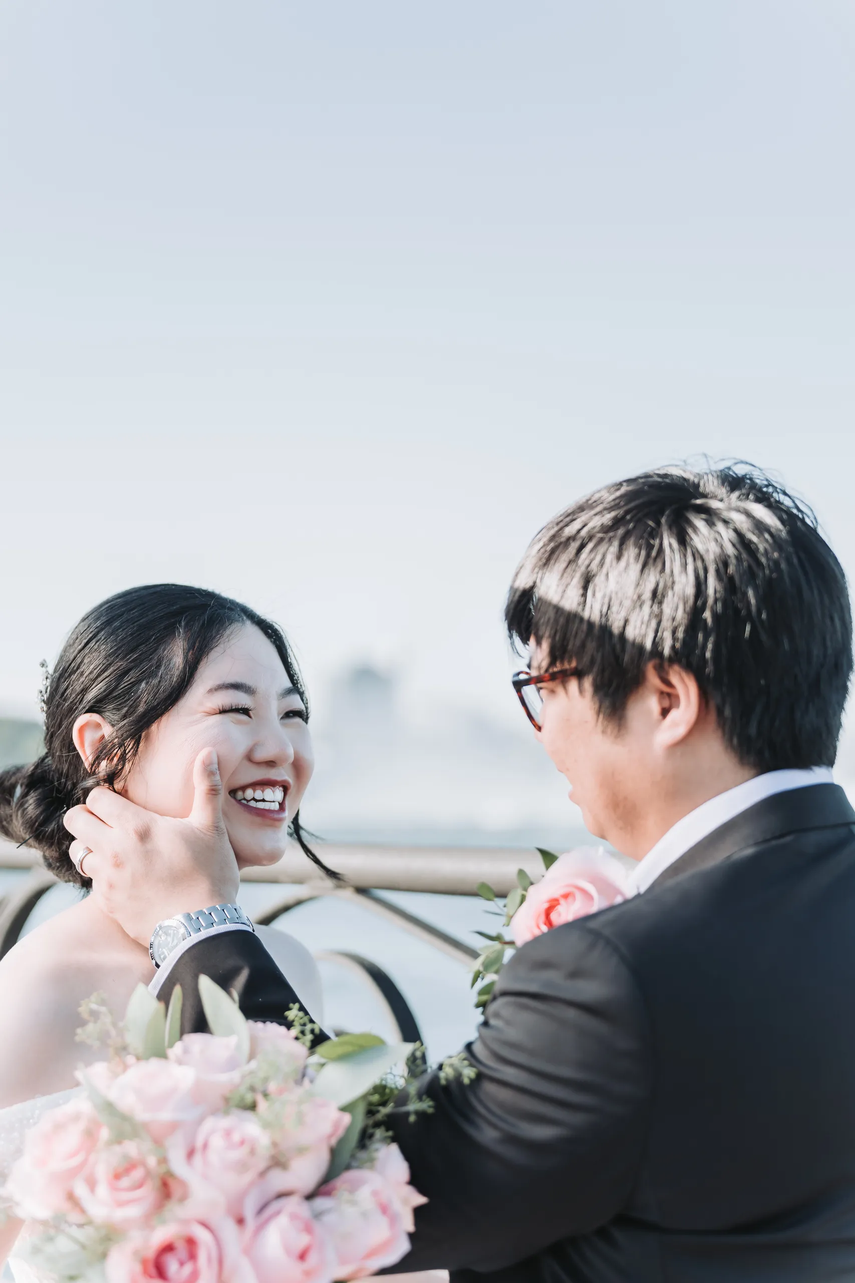 Micheal's hand on Karen's cheek as she laughs, mist from Horseshoe Falls behind them, by AD Photography