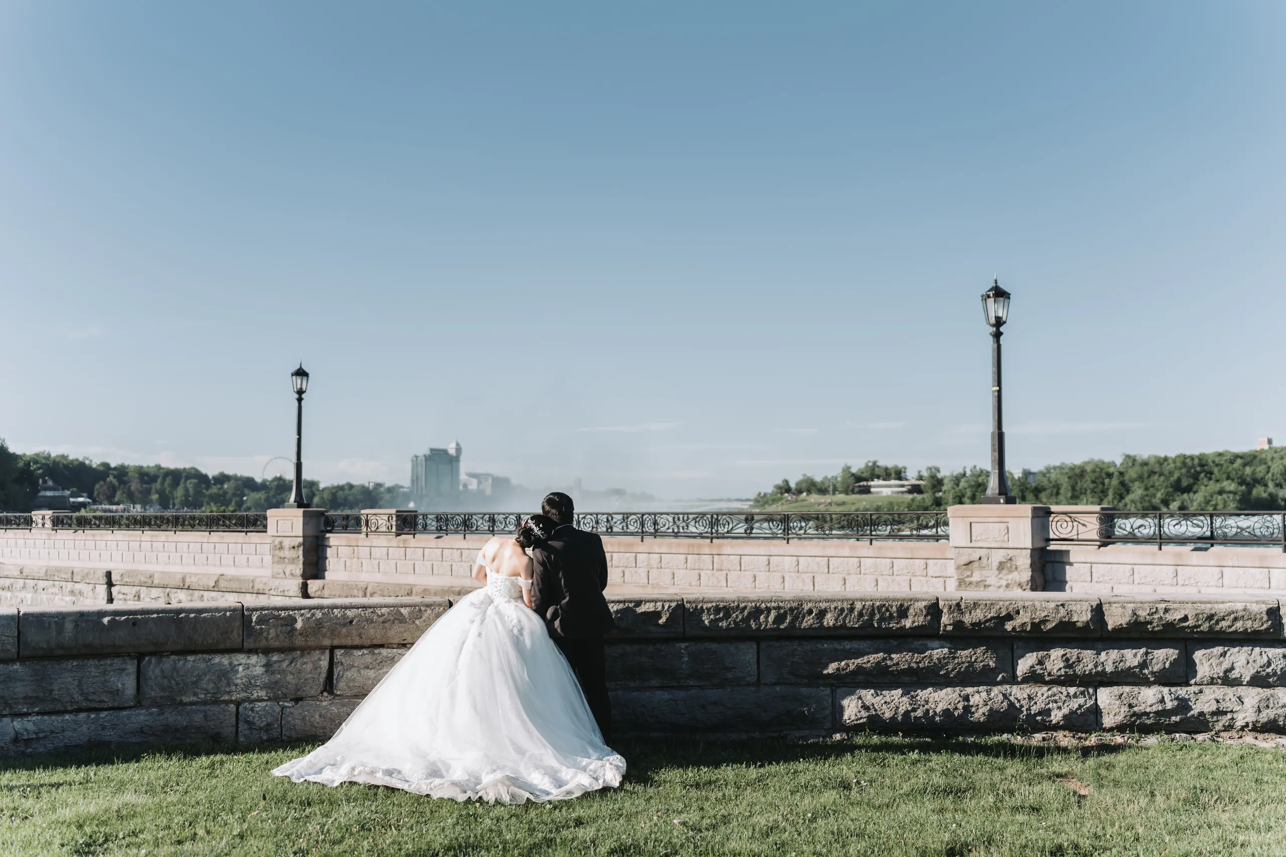 Karen and Micheal sitting on the lawn at the stone balustrade above the Niagara gorge, by AD Photography