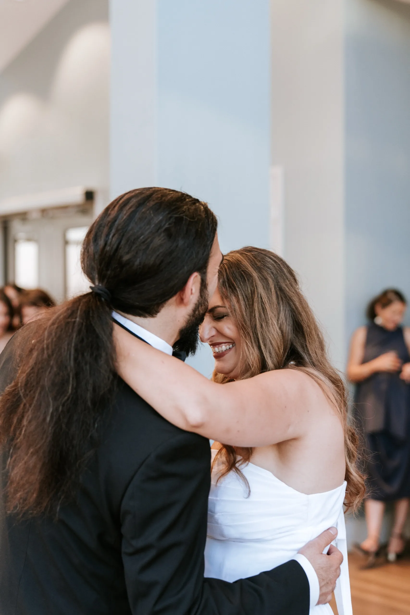 Zoha closes her eyes smiling with her arms around Moe's neck on the dance floor, by AD Photography