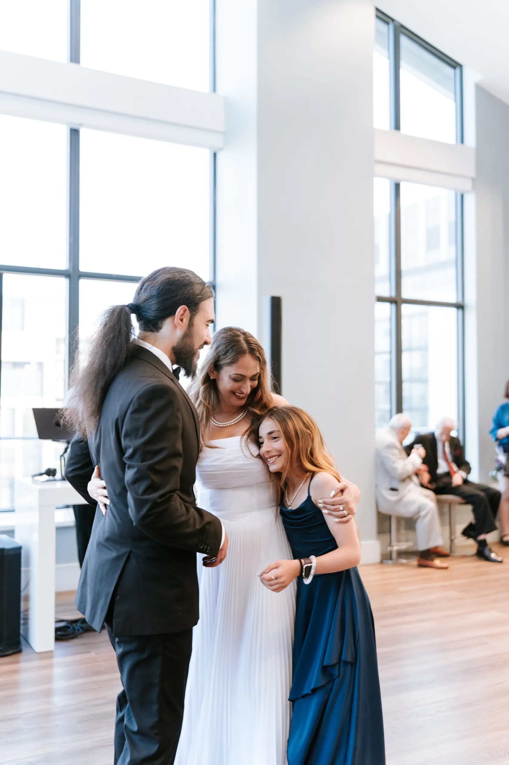 A girl in navy tucks into Zoha and Moe as the three of them dance together, by AD Photography