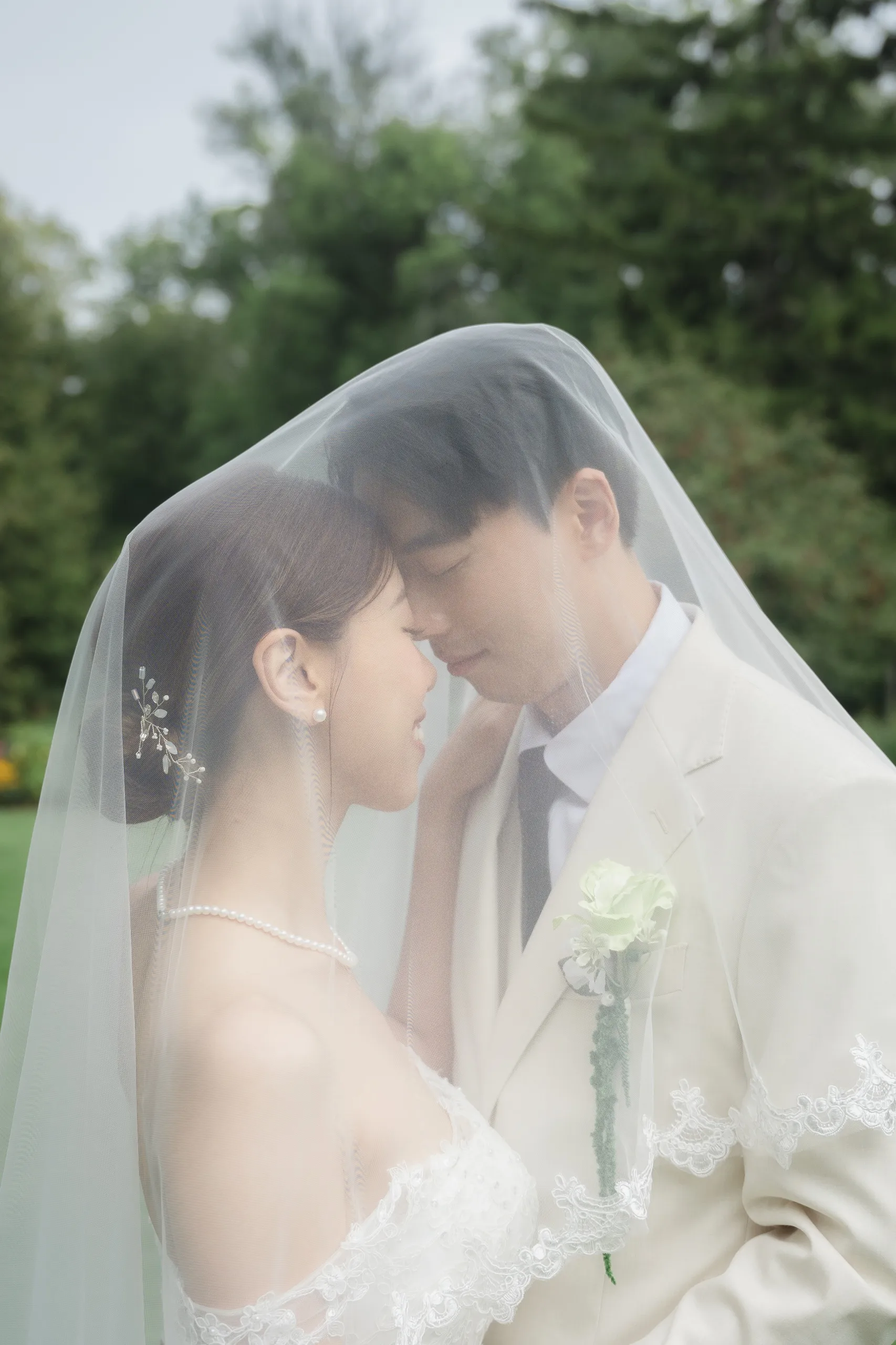 Josie and Nelson forehead to forehead under her veil at Guild Park, Toronto wedding photography by AD Photography